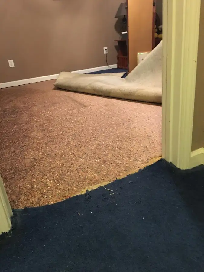 Carpet pad removal revealing water damage during Drying & Dehumidification in Green Bay